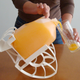 Illustration for article titled Roll n Pour: A Rocking Chair For Your Gallon Jugs